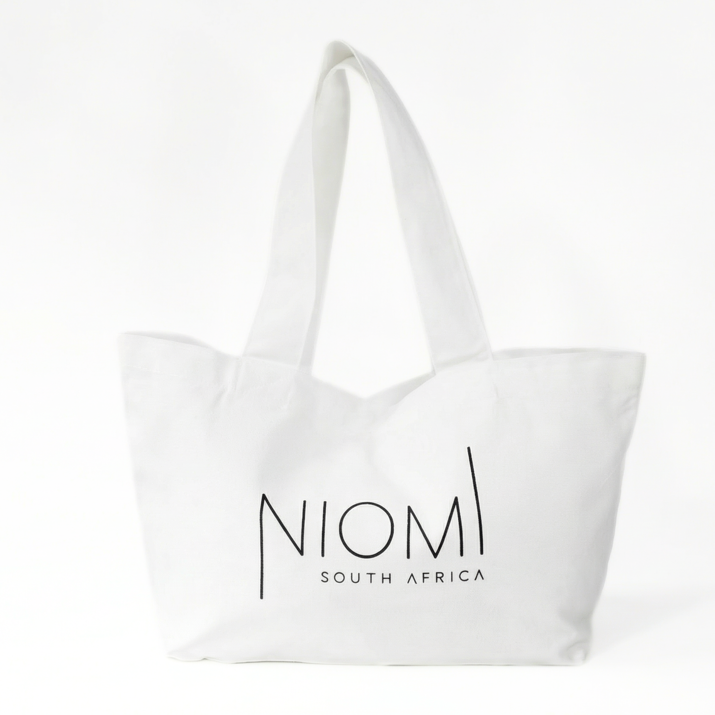 NIOMI large white tote bag with black NIOMI logo, stylish everyday carry bag for beach, gym, and shopping