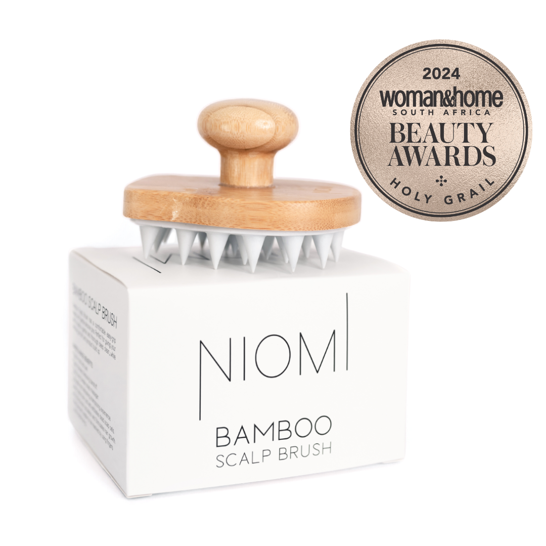 NIOMI Bamboo Scalp Massage Brush packaging with the brush displayed on top. The packaging has the brand name and '2024 Woman & Home Beauty Awards