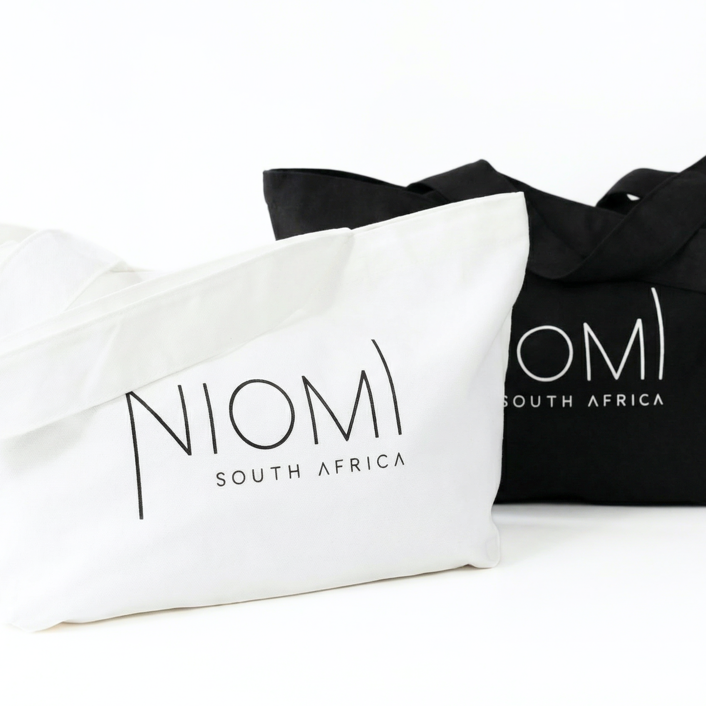 NIOMI large black and white tote bag both with  NIOMI logo, stylish everyday carry bag for beach, gym, and shopping
