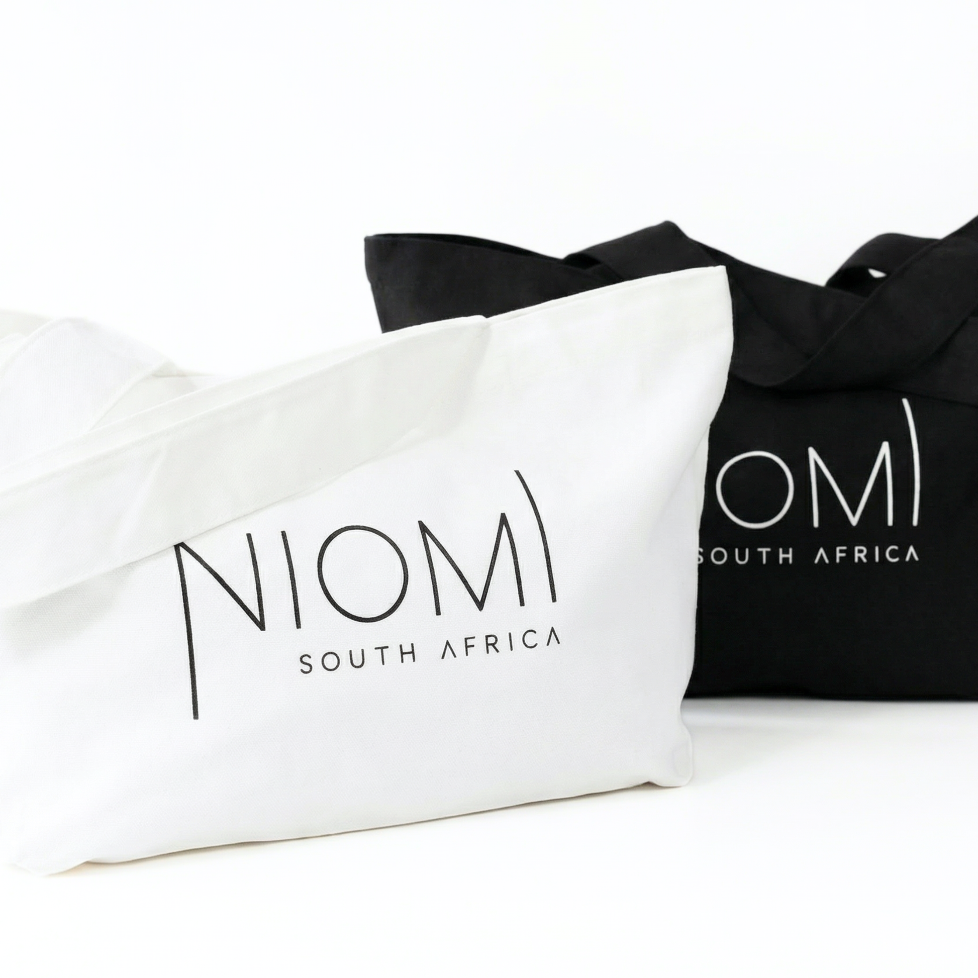 NIOMI large black and white tote bag both with  NIOMI logo, stylish everyday carry bag for beach, gym, and shopping