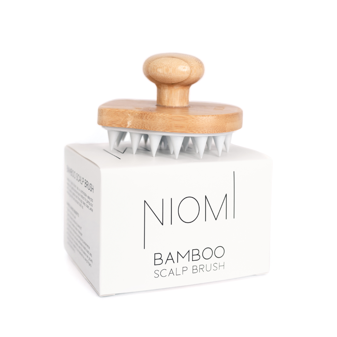 NIOMI Bamboo Scalp Brush on top of box