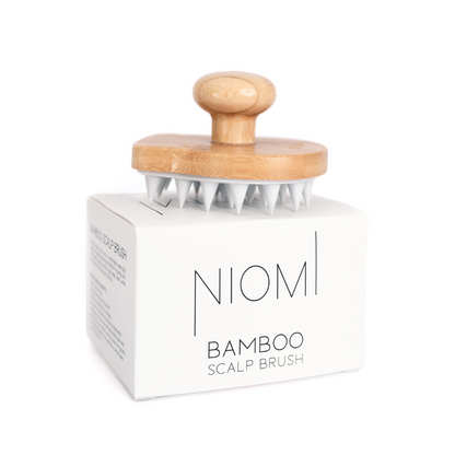 NIOMI Bamboo Scalp Brush on top of box