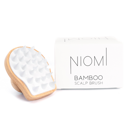 NIOMI Bamboo Scalp Massage Brush packaging with the brush displayed on right