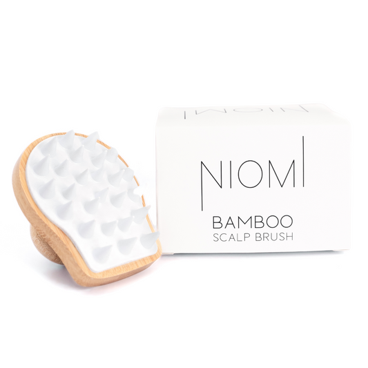 NIOMI Bamboo Scalp Massage Brush packaging with the brush displayed on right